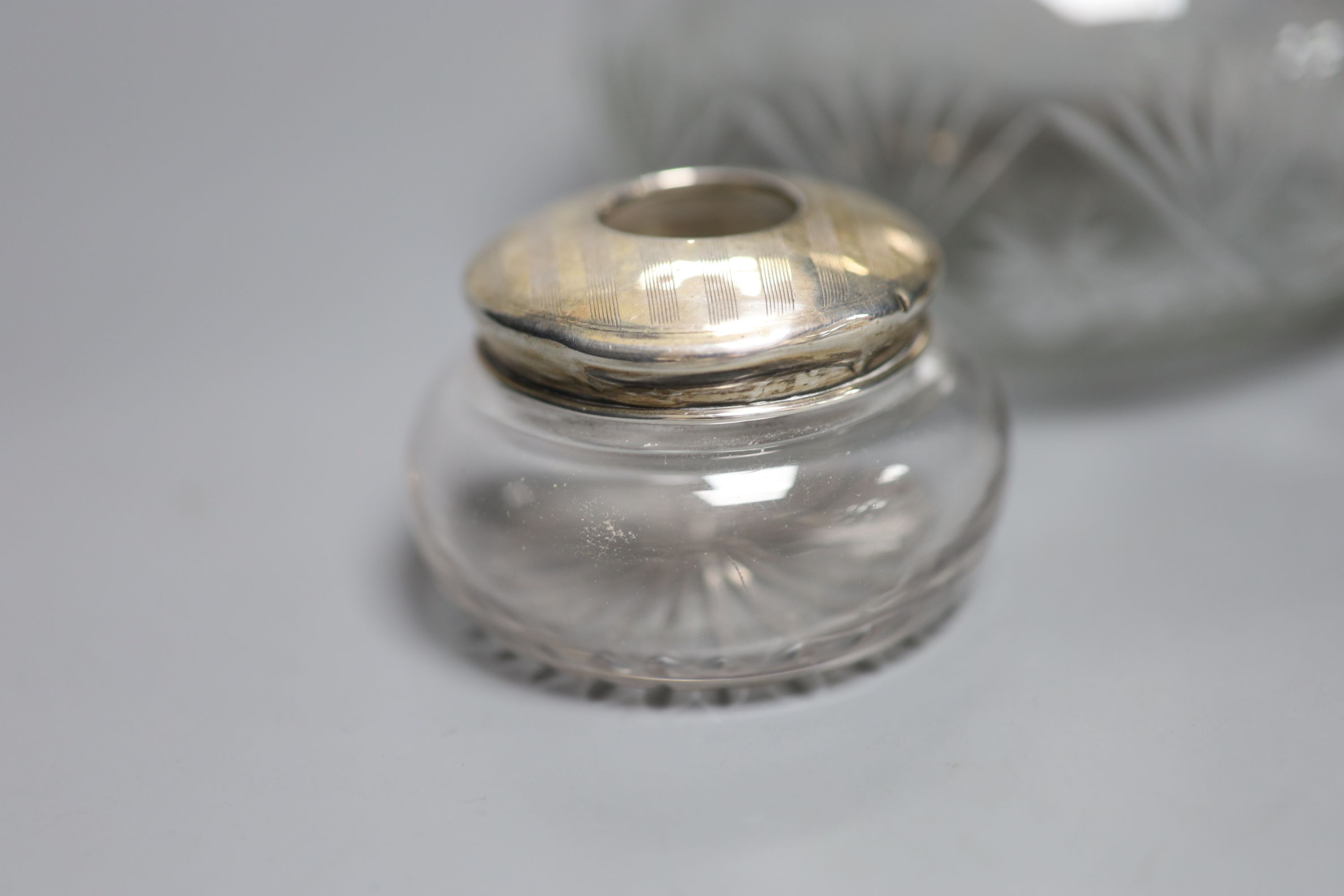 A 1920's silver mounted cut glass powder bowl, a similar small hair tidy and a silver napkin ring.